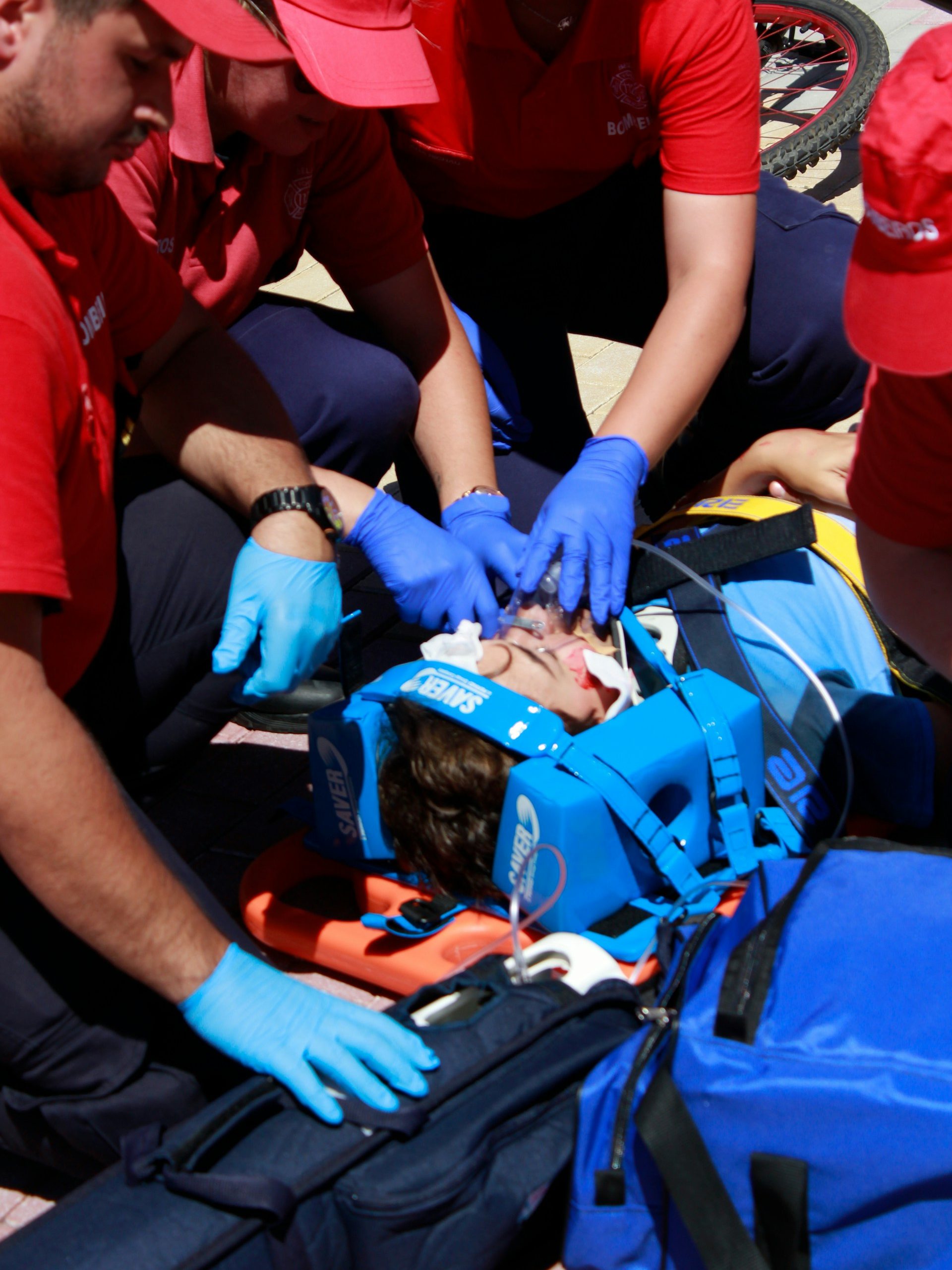 people performing first aid medical care to an injured man